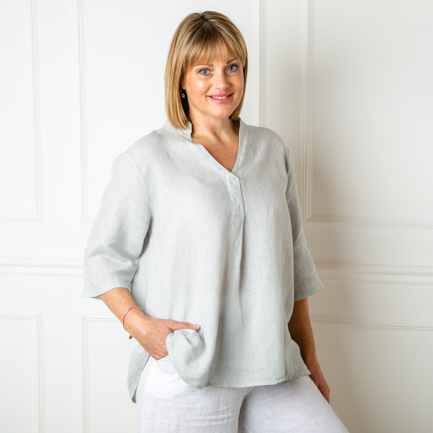 The Linen Tunic Top in dove grey with 3/4 length sleeves and a collarless v neckline